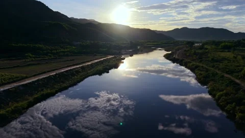 Mirror-like river reflection during golden hour in Vietnam Stock Footage 336610345