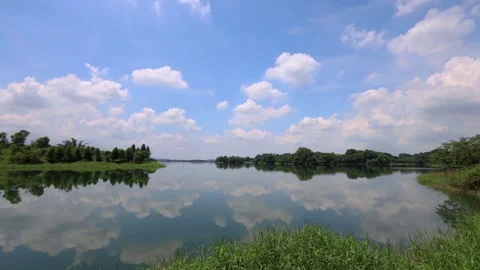 Mirror of the sky over the lake. White cloud, picturesque landscape view.4K Stock Footage 258921997