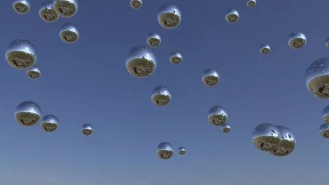 Mirror spheres flying in the sky reflect the surrounding atmosphere. Seamless Stock Footage 137782053