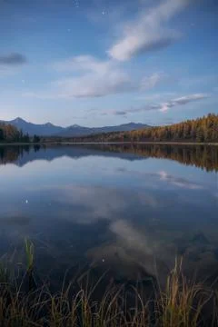 Mirror Surface Lake Vertical Orientation Autumn Landscape With Mountain Range In Stock Photos