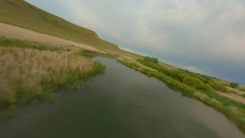 The mirror surface of the river reflects the cloudy sky. The shores of the Stock Footage 157214304