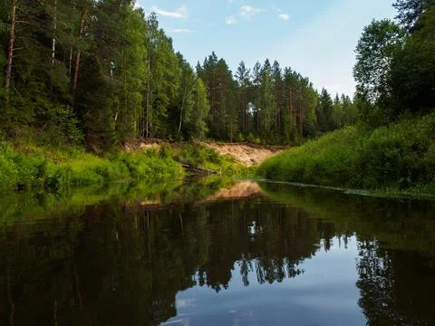 Mirror surface of the river water surface in the middle of the forest. Silenc Stock Photos