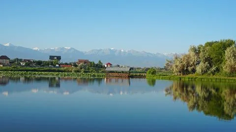 The mirror surface of the water reflects mountains Stock Photos