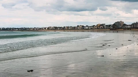 Mirror-like surface of wet sand and small waves at low tide. Stock-Footage 311950745