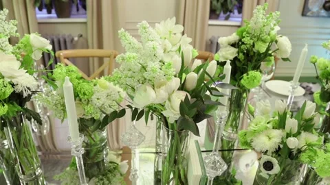 Mirror table, candles, vases with white flowers for the holiday Stock Footage 131181702