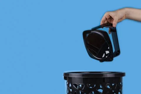 The mirror is thrown into the trash can. Stock Photos