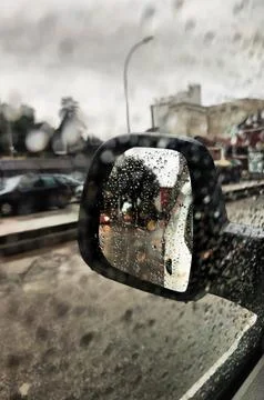 Mirror view with the car in the rain Stock Photos
