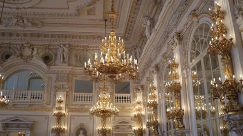 Mirror wall reflections golden chandeliers glowing statues and intricate molding Stock Footage 306677137