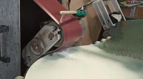 Mirror working on grinding machine. Cooling of heating part during glass work Stock-Fotos