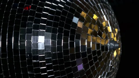 A mirrored disco ball in close-up rotates at a party. Rays of different colors Video stock 165570924