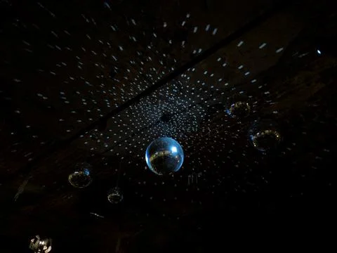 Mirrored disco ball hanging down. Retro style mirror disco balls hanging from Stock Photos