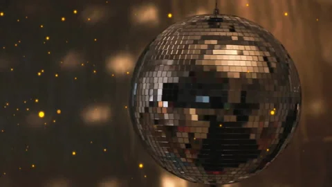 Mirrored disco ball spinning in dimly lit party scene, projecting floating Stock Footage 308069206