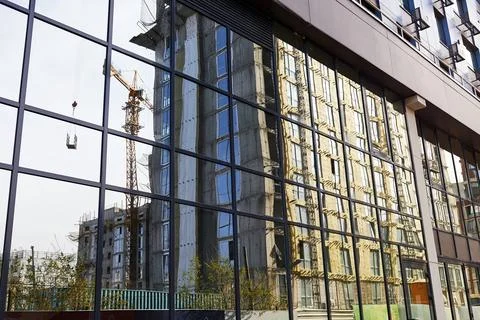 Mirrored facade of the building with reflection of the building Stock Photos