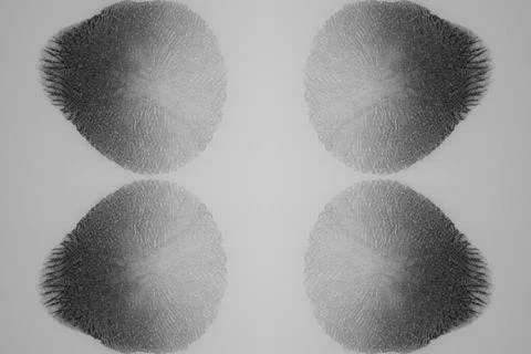 A mirrored gray pattern of fluids  creates a peaceful background Stock Photos