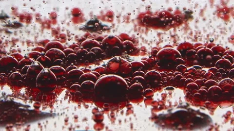 Mirrored surface with red bubbles slow motion Stock Footage 132188699