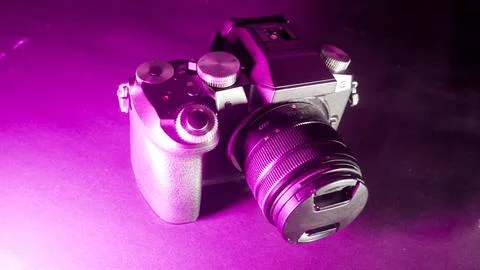 Mirrorless camera with purple light Stock Photos