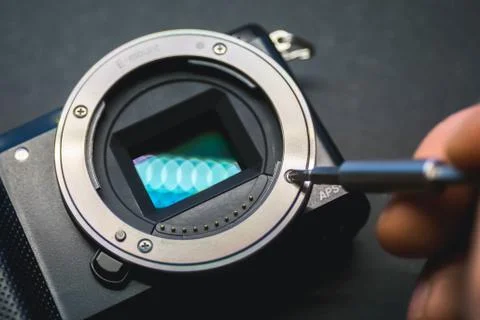 Mirrorless camera sensor repair, screwdriwer over lens mount. 写真素材