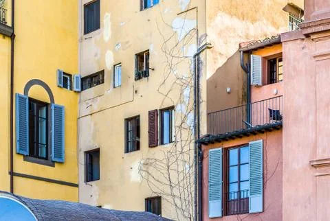 Misc old and new windows on the pink and yellow walls Stock Photos