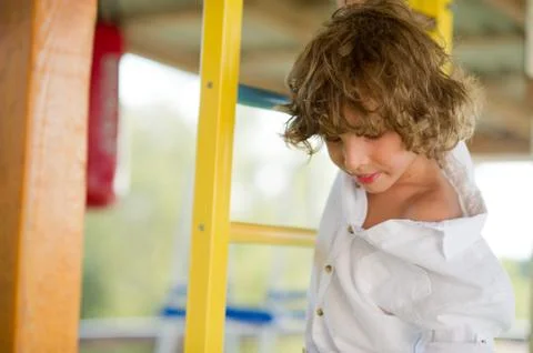 Mischievous boy 10-11 years old on the playground. Stock Photos