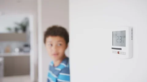 Mischievous Boy Changes Temperature On Central Heating Thermostat Control Before Stock Footage 119842435