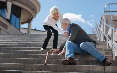 Miserable man asking for help on stairs Stock Photos