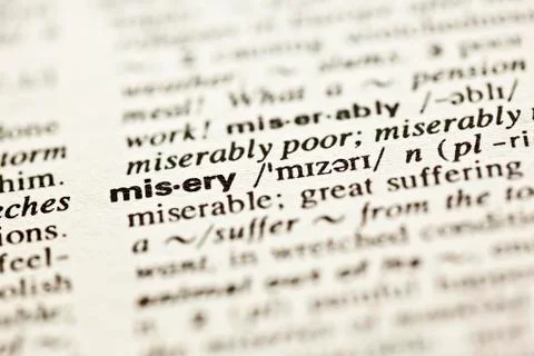 'misery' - dictionary definition Stock Photos