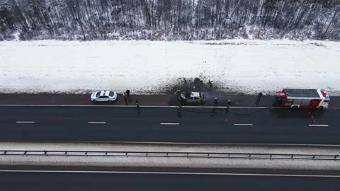 Misfortune - a burned-out car on the edge of a motorway, aerial view. Stock Footage 225836503