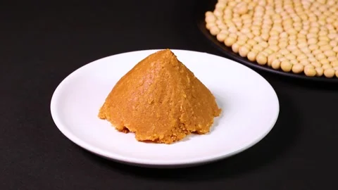 Miso and soybeans on black background, rotating Stock Footage 304254038