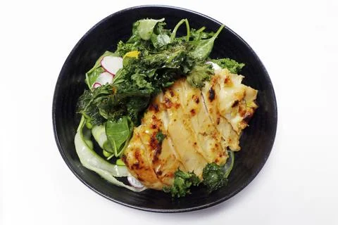 Miso paste glazed chicken mixed vegetable and lettuce salad in a bowl with wh Stock-Fotos
