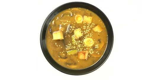Miso soup. vegetarian soup in a black dish on a white background. 스톡 동영상 229684553