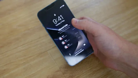Missed son calls on smartphone, hand holds lock screen, child boy missed call Stock Footage 337690281