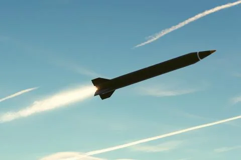 Missile accelerates in sky with bright flame from rocket engine nozzle. Stock Photos