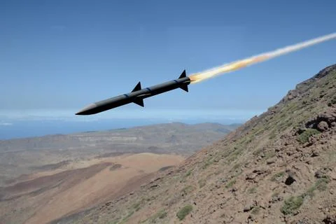 Missile with fire in flight over mountainous Middle East region Fotos Stock