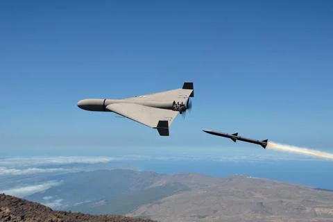 A missile shoots down a drone during an air strike over mountainous terrain. Fotos de archivo