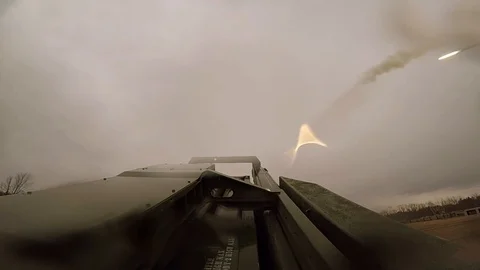 Missiles being fired into a large open field Stock Footage 113344239