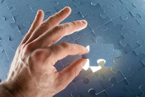 Missing jigsaw puzzle piece with light glow Stock Photos
