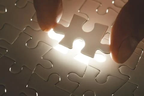 Missing jigsaw puzzle piece with light glow Stock-Fotos