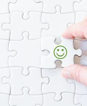 Missing jigsaw puzzle piece with smiling emotion face Stock Photos