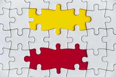 Missing jigsaw puzzle in red and yellow color with customizable space for text Stock Photos