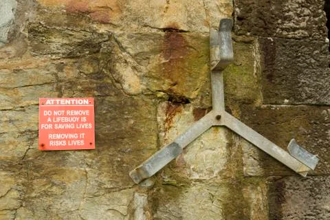 Missing lifebuoy with warning Stock Photos