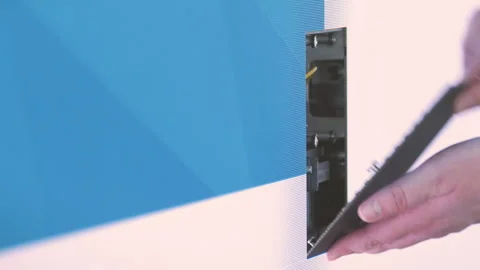 Missing part of an LED wall module is installed by technician and Stock Footage 286714827