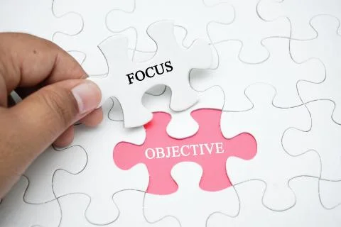 Missing pizzle with a word FOCUS OBJECTIVE Stock Photos