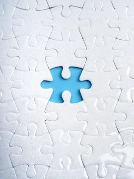 Missing puzzle piece concept with white jigsaw and empty blue space. Symbol.. Stock Photos