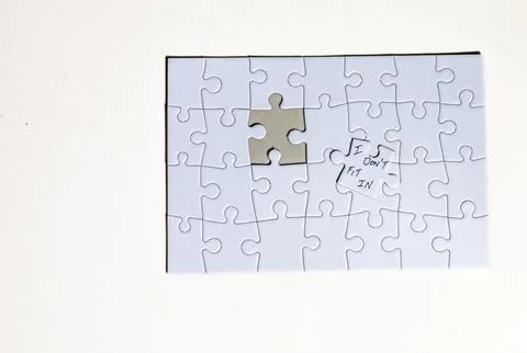 Missing Puzzle Piece With a Note Shows Feelings of Not Belonging in a Group.. 写真素材