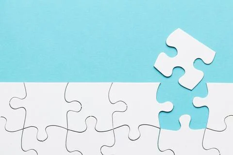 Missing puzzle piece with white puzzle grid blue background Resolution and high Stock Photos