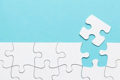 Missing puzzle piece with white puzzle grid blue background. High quality b.. Stock Photos