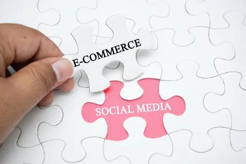 Missing puzzle with a word E-commerce and social media Stock Photos