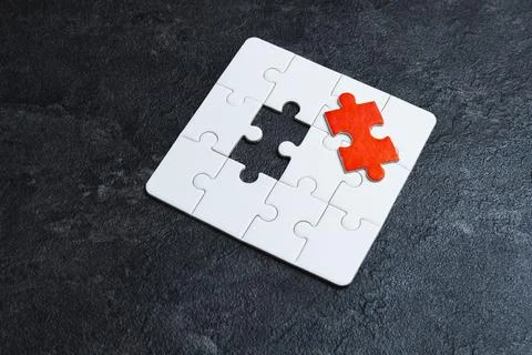 Missing red piece of a white puzzle. Stock Photos