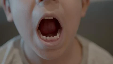 Missing tooth. Close up on a smiling kid showing milk tooth missing and growing Stock Photos