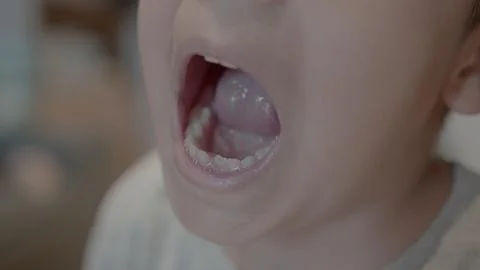 Missing tooth. Close up on a smiling kid showing milk tooth missing and growing Stock Photos